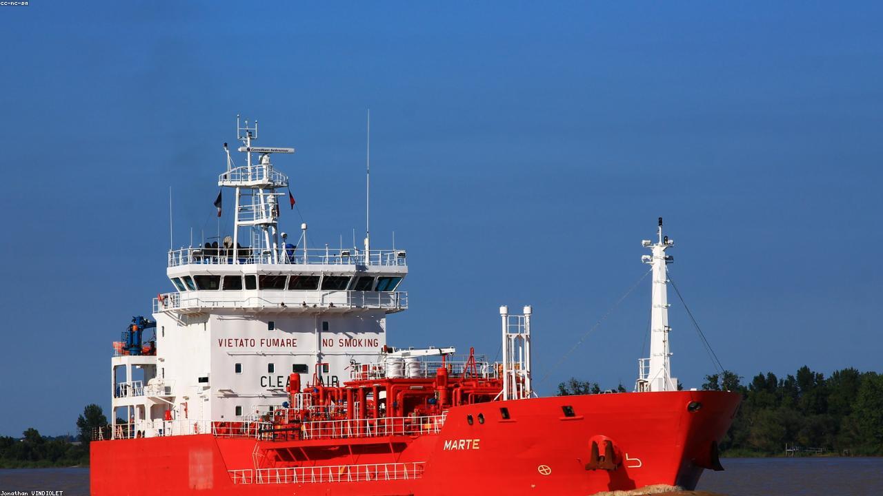 Oil tanker berthed at a petroleum import terminal at dusk